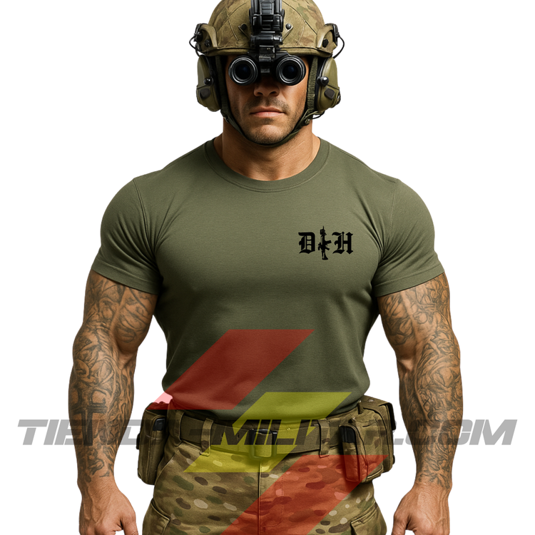 Hombre de frente con camiseta táctica fabricada en poliéster, en color VERDE MILITAR de la marca Depredador Hispano. En el pecho lleva un logotipo con con las iniciales de la marca (DH) y un fusil de asalto G36 en vertical. Ropa militar de alto rendimiento con diseño reivindicativo de poder hispano.